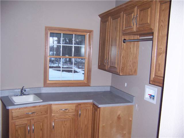 Oak cabinets - laminate countertop - Clothes rod